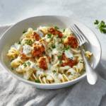 cajun chicken bites with creamy garlic herb alfredo twists