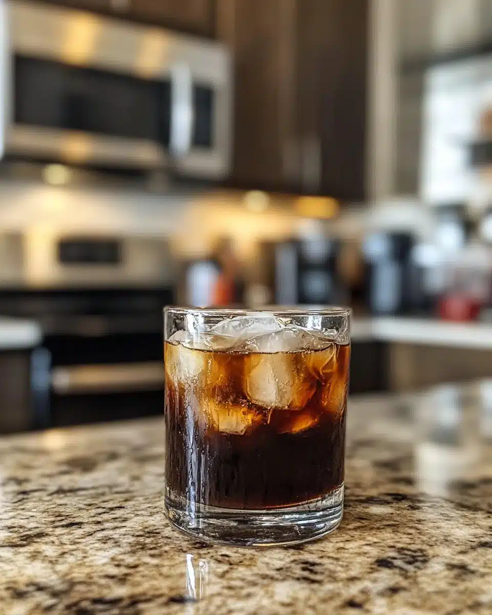 A refreshing glass of vanilla brown sugar iced coffee topped with cream.